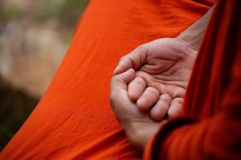 close up of a Buddhist monk's hands held in his lap during meditation