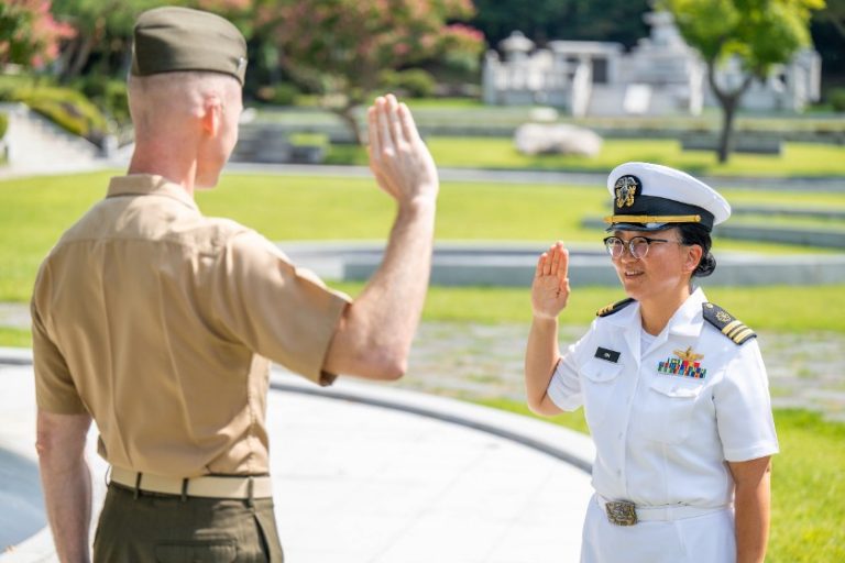 Lt. Cmdr. Saejeong Kim and commanding officer at ceremony