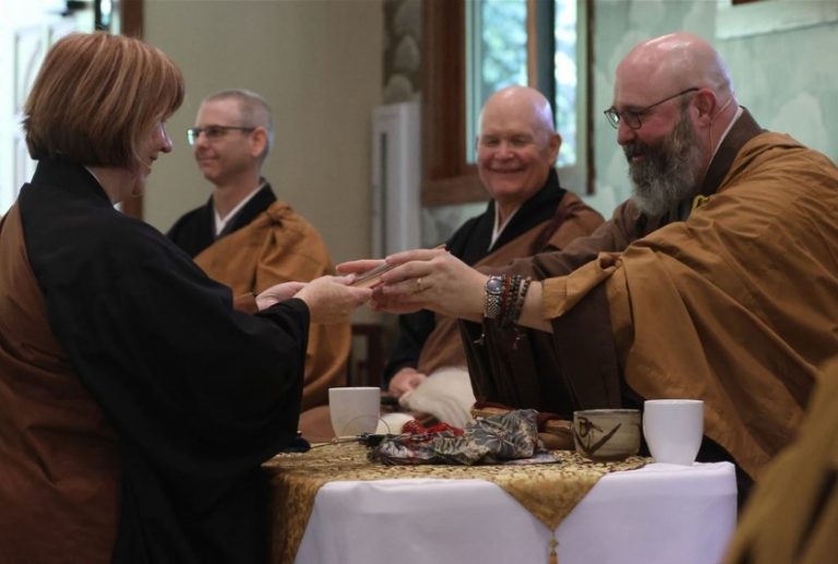 Buddhists in robes are pictured during a ceremony