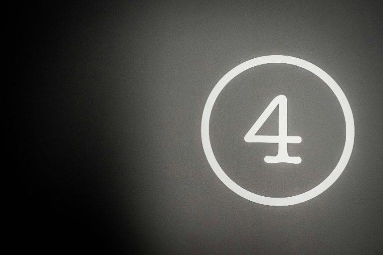 the number four with a circle around it on a black background