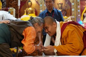 lama touching heads with a devotee