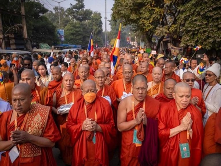 Buddhist monastics in prayer standing